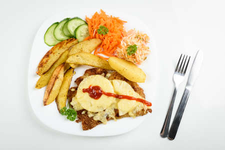 Hawaiian cutlet with baked potatoes and a bouquet of saladsの写真素材