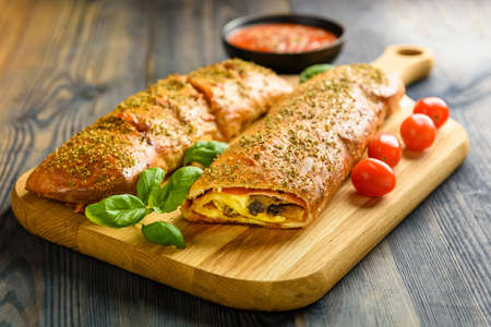 Pizza stromboli on a wooden backgroundの写真素材