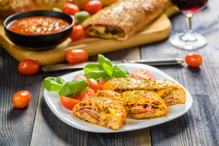 Pizza stromboli on a wooden backgroundの写真素材