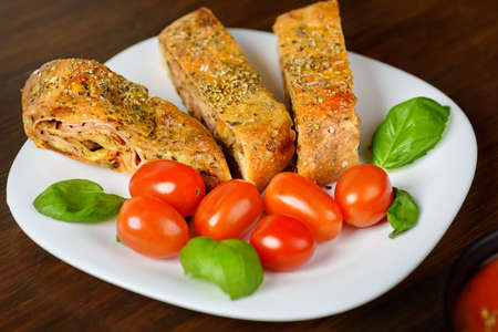 Pizza stromboli on a wooden backgroundの写真素材