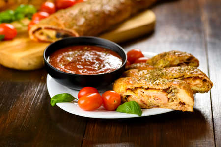 Pizza stromboli on a wooden backgroundの写真素材