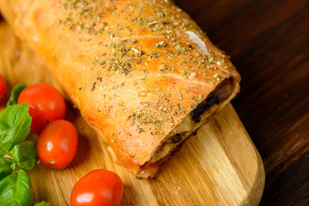 Pizza stromboli on a wooden backgroundの写真素材