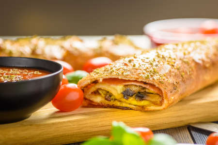 Pizza stromboli on a wooden backgroundの写真素材