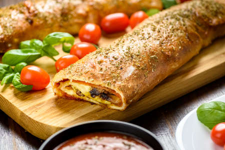 Pizza stromboli on a wooden backgroundの写真素材