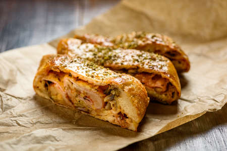 Pizza stromboli on a wooden backgroundの写真素材