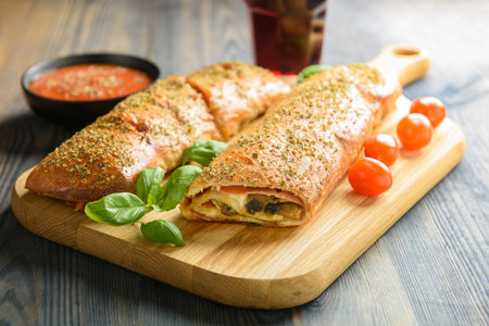 Pizza stromboli on a wooden backgroundの写真素材
