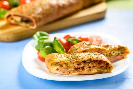 Pizza stromboli on a wooden backgroundの写真素材
