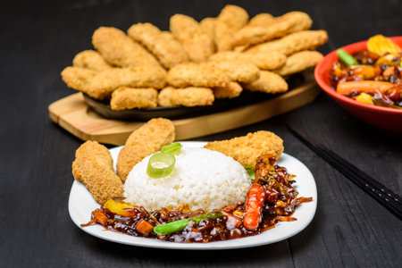 hot rice serving on a white plate on wooden tableの写真素材