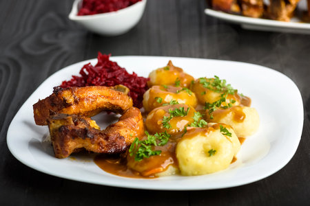 Ribs in honey and Silesian dumplings served with beetroot and sauceの写真素材