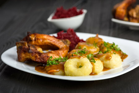 Ribs in honey and Silesian dumplings served with beetroot and sauceの写真素材
