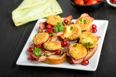 sandwich with fried camembert cheese, bacon and cranberriesの写真素材