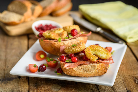 sandwich with fried camembert cheese, bacon and cranberriesの写真素材