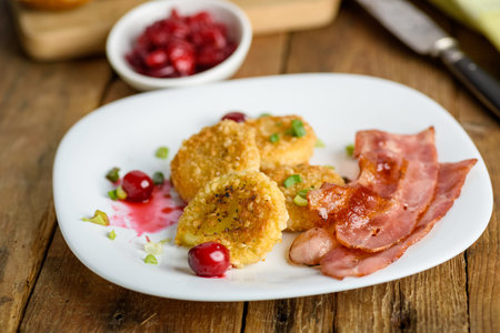 sandwich with fried camembert cheese, bacon and cranberriesの写真素材