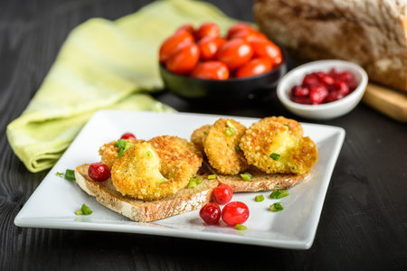 sandwich with fried camembert cheese, bacon and cranberriesの写真素材