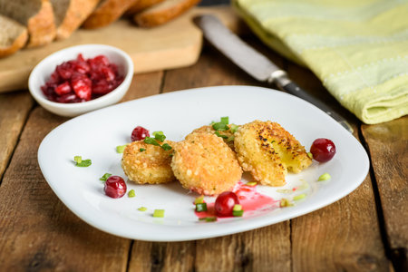 sandwich with fried camembert cheese, bacon and cranberriesの写真素材