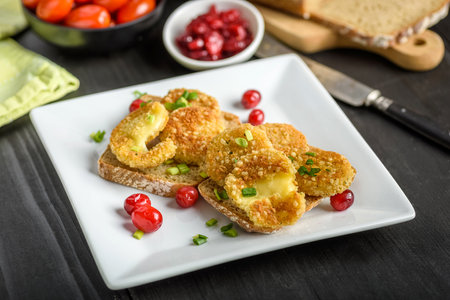 sandwich with fried camembert cheese, bacon and cranberriesの写真素材