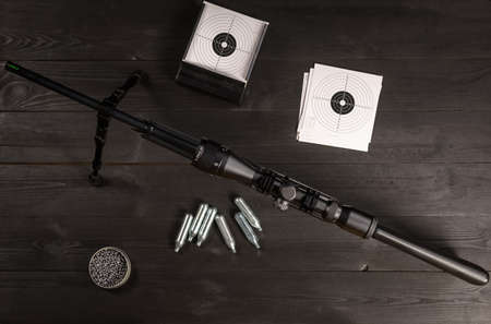 air rifle carabiner on wooden tableの写真素材