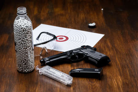 pistol replica, shield, glasses, speedloader and plastic balls - preparation for the game - side weaponの写真素材
