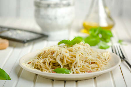 pasta with pepper and bacon sprinkled with grated cheeseの写真素材