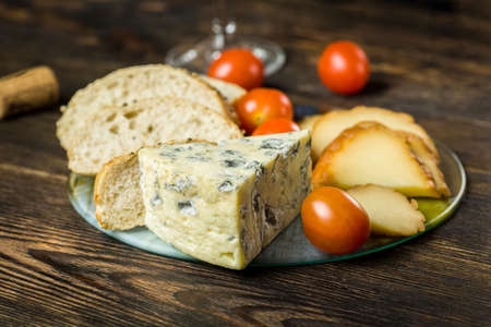 cheese board on a wooden tableの写真素材