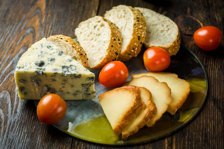 cheese board on a wooden tableの写真素材