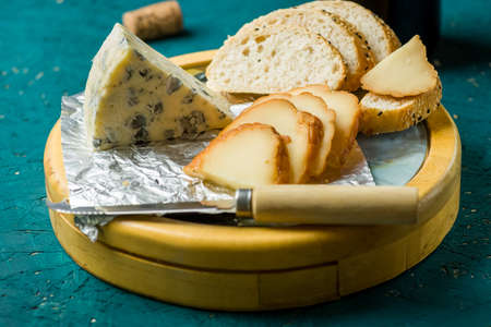 cheese board on a wooden tableの写真素材
