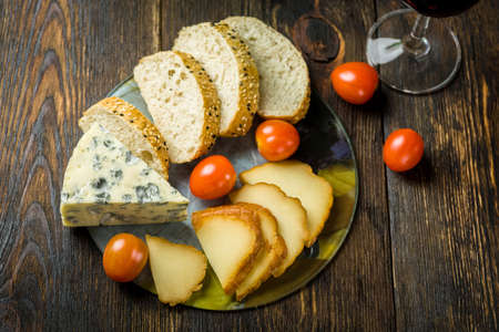 cheese board on a wooden tableの写真素材
