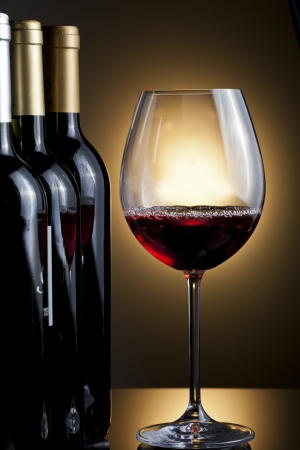 Bottles and glass of wineの写真素材