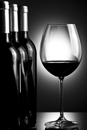 Bottles and glass of wineの写真素材