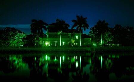 Beautiful night shot of mansion on the waterの写真素材