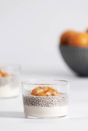 Chia seed pudding with apricot, almond and yogurt in glass. Clean eating, healthy vegan vegetarian food concept.の写真素材