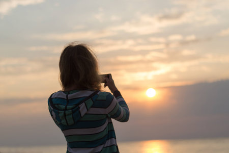 girl on the beach photographs dawn sunの写真素材