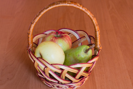 small basket with apples and pearsの写真素材