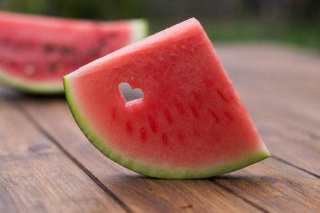 sliced ââwatermelon on a wooden backgroundの写真素材