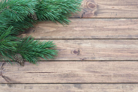 Christmas-tree branch on a wooden background