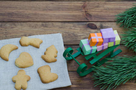 Christmas theme with sleigh and presents and place for an inscription on a wooden backgroundの写真素材