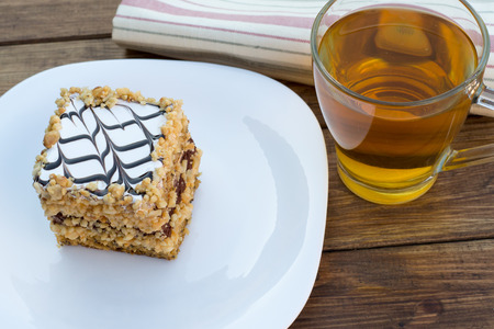 cake and cup of tea on a wooden table
