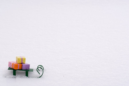 small gifts in colorful paper for decorative sledding in the snowの写真素材