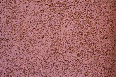 maroon monochrome wall with formless cement backgroundの写真素材