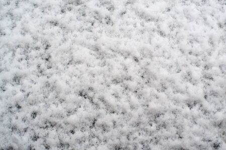 white snow on the ground close-up for background with space for writingの写真素材
