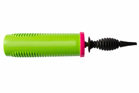 Green manual plastic pump for inflating balls and balloons close-up on a white background