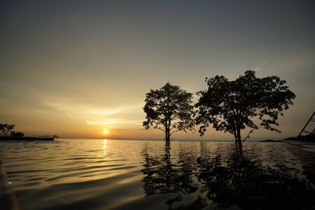 Water pool vacation with sunset backgroundの写真素材