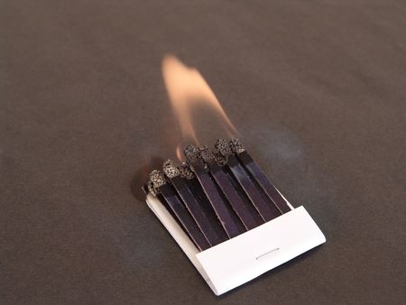 book of matches with flame isolated on black backgroundの写真素材