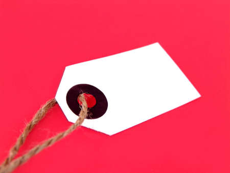 price or gift tag with twine isolated on solid background