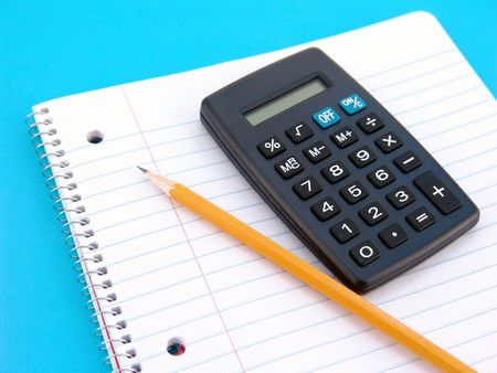 note book with pencil and calculator