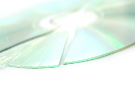 broken and cracked CD / DVD on white backgroundの写真素材
