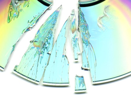 broken and cracked CD / DVD on white backgroundの写真素材