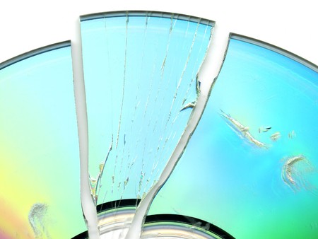 broken and cracked CD / DVD on white background