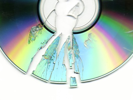 broken and cracked CD / DVD on white background