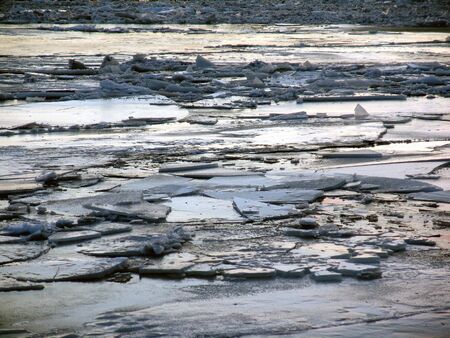 ice on surface of river, cracked and broken after thaw